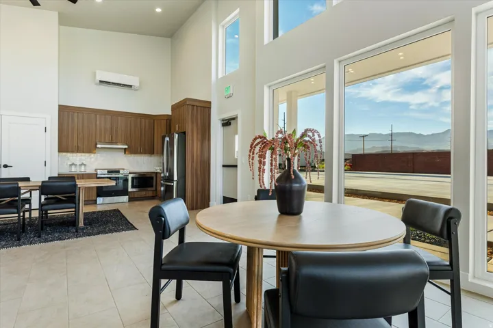 Tile flooring, high ceilings, wood cabinetry, stainless steel appliances, and large windows