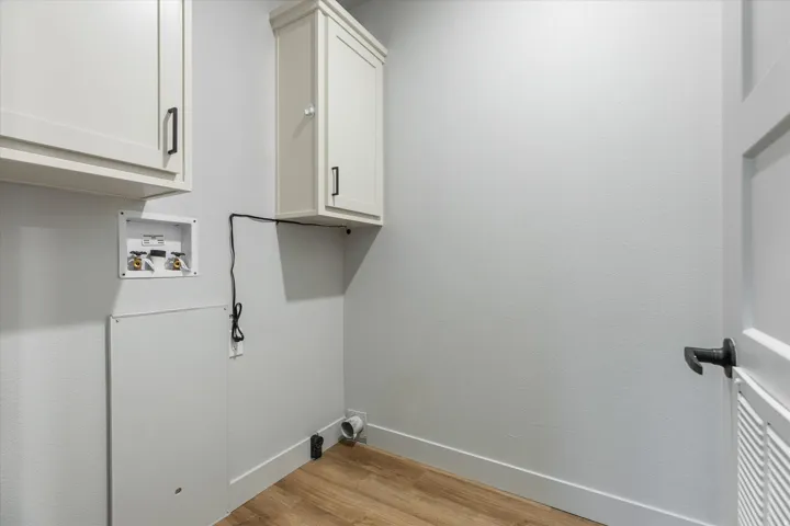 Wood-finish flooring with white baseboards