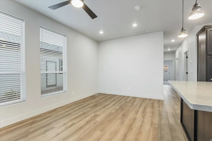 Wood-finish flooring, recessed lighting, and a modern ceiling fan