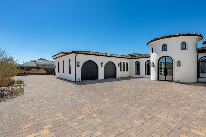Spanish Colonial Revival architecture with a rounded turret and a tile roof