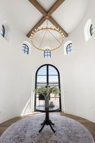 Distinctive octagonal room featuring soaring vaulted ceilings with exposed timber beams and geometric skylight design