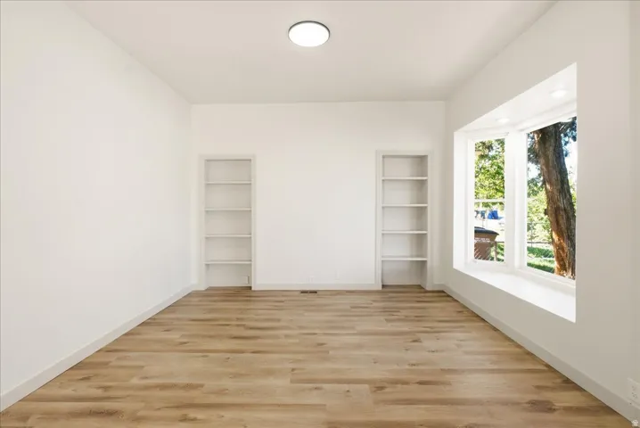 Wood-finish flooring with white walls and trim