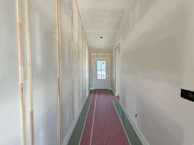 Entryway with board and batten wall detailing, recessed lighting, and a white paneled door with glass inserts