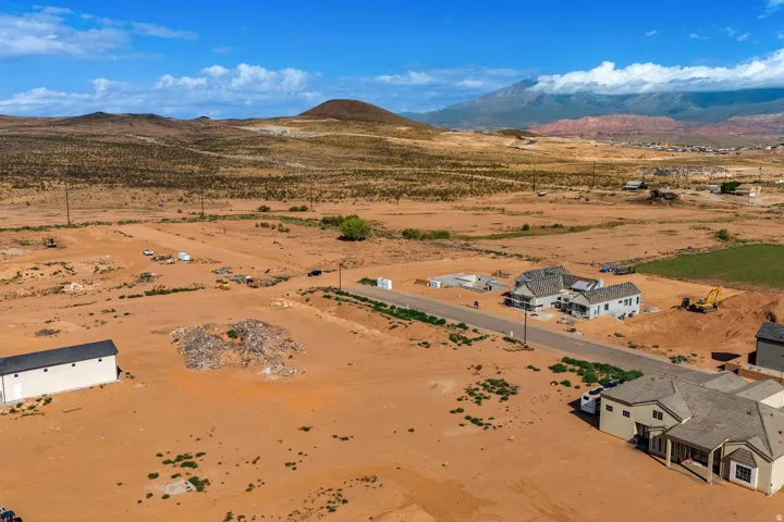 Expansive desert landscape with distant mountains under a blue sky