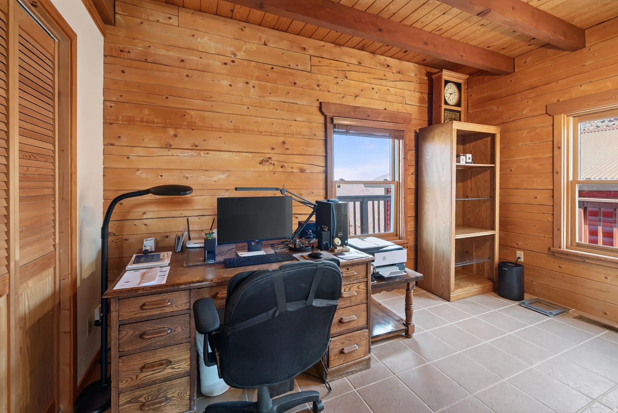 Wood-paneled walls and ceiling with exposed beams