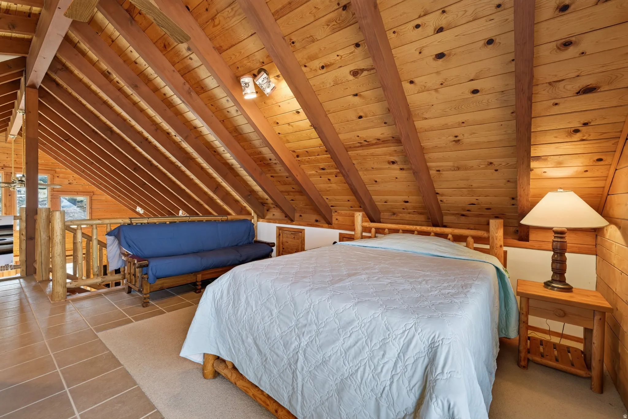 Angled wood-paneled ceiling with exposed beams