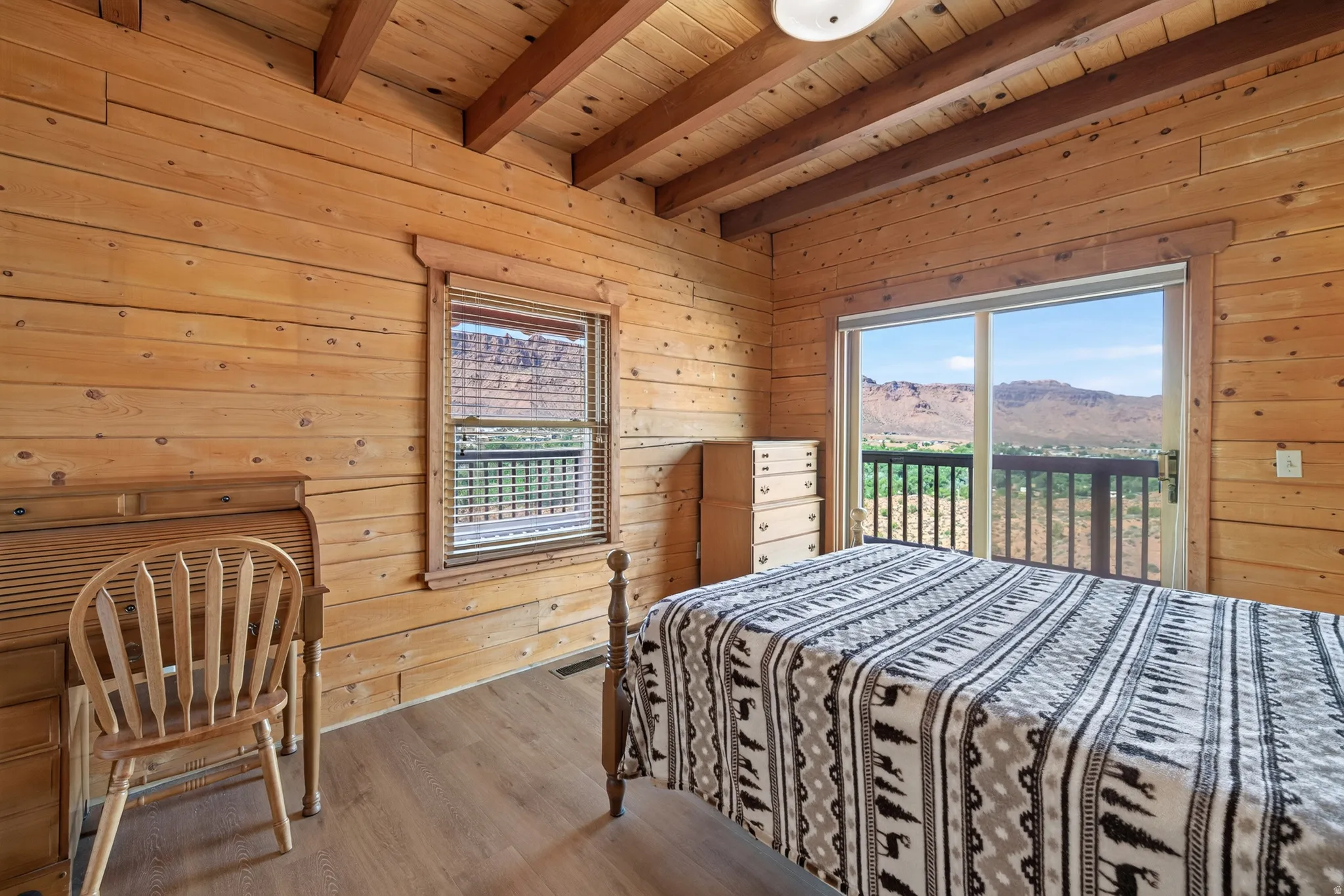 Wood-paneled walls and ceiling with exposed beams
