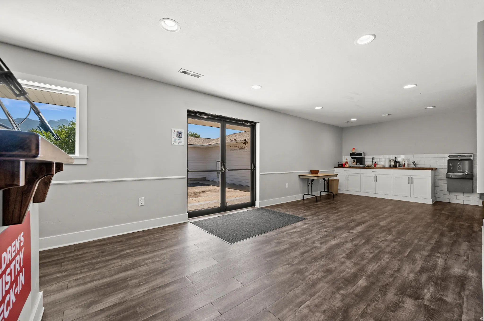 Wood-finish flooring throughout, with recessed lighting and a window offering natural light