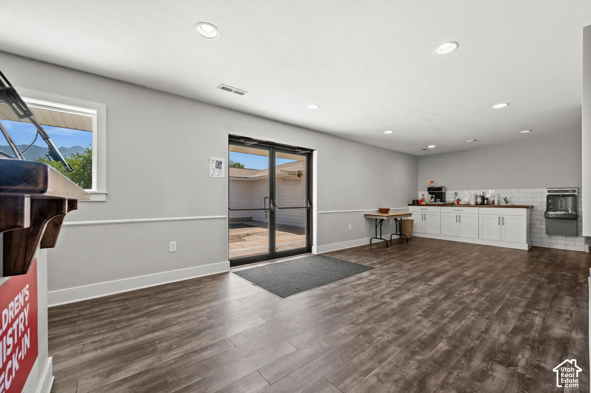 Wood-finish flooring throughout, with recessed lighting and a window offering natural light
