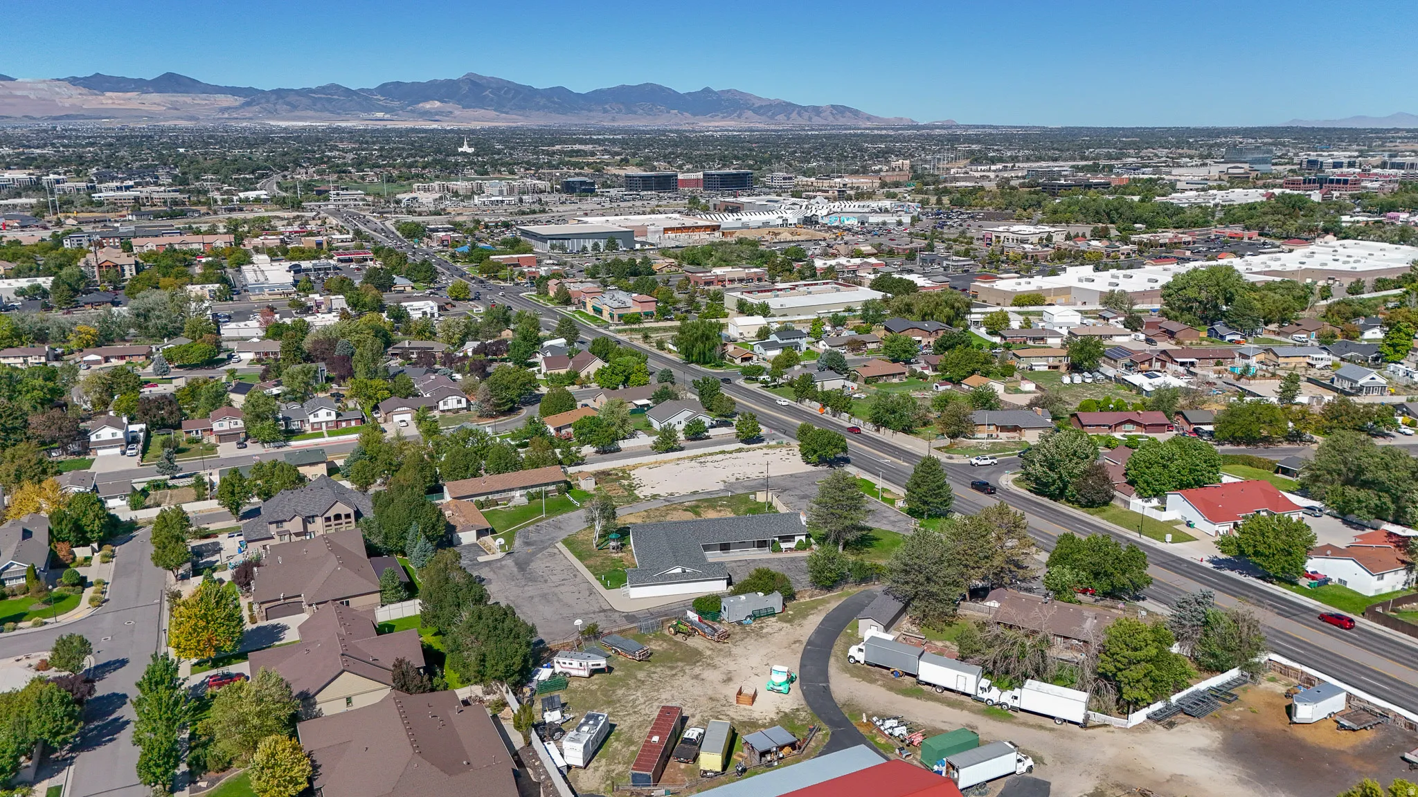 Aerial overview of a developed urban area with varied residential and commercial structures