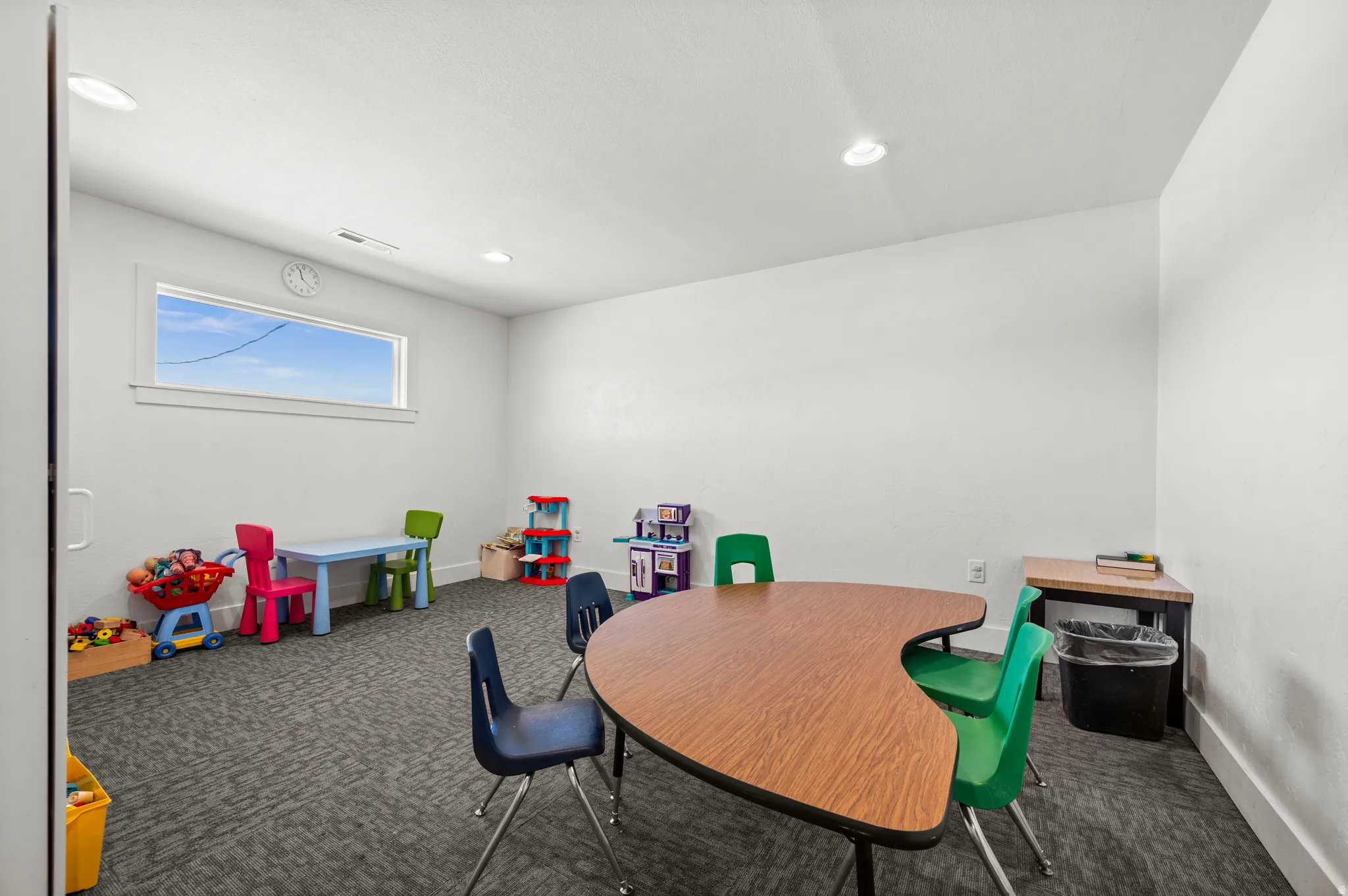 Recessed lighting, large window, and carpeted flooring