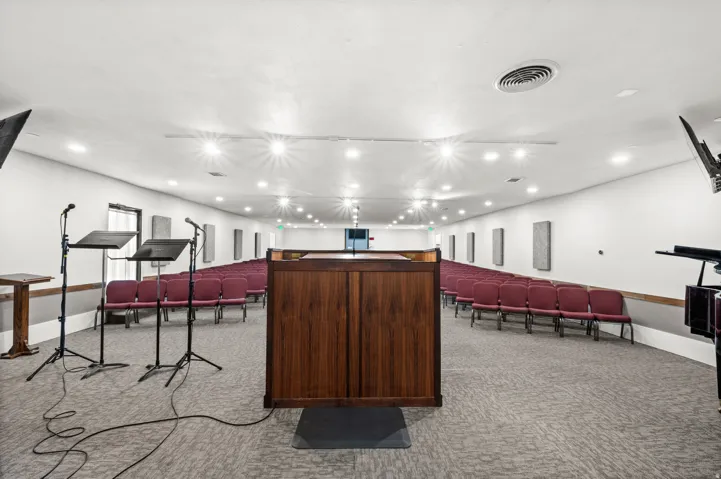 Spacious interior with recessed lighting, textured carpet flooring, and integrated wall panels