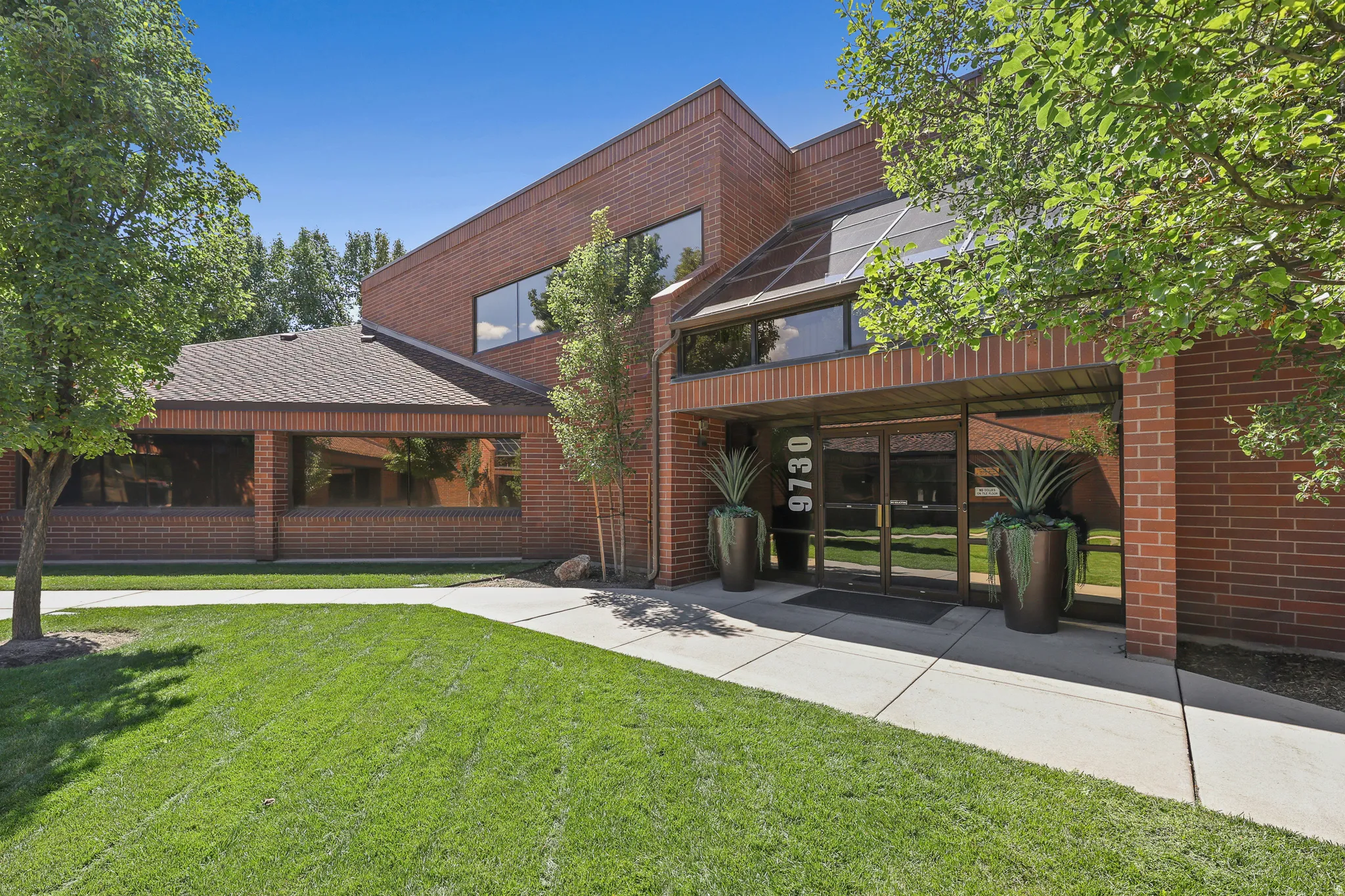 Brick exterior with a gabled roof and large windows