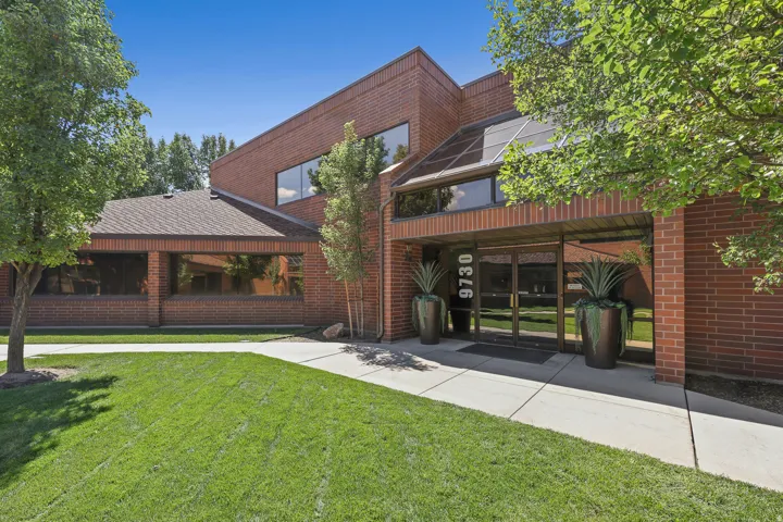 Brick exterior with a gabled roof and large windows