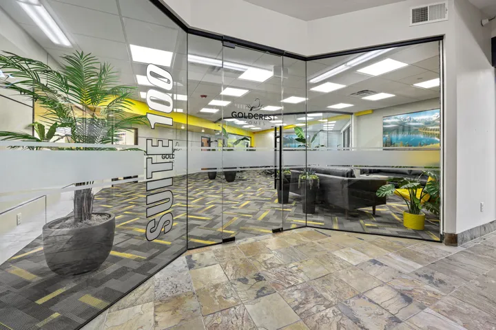 Glass wall with frosted elements, patterned flooring, and recessed ceiling lighting