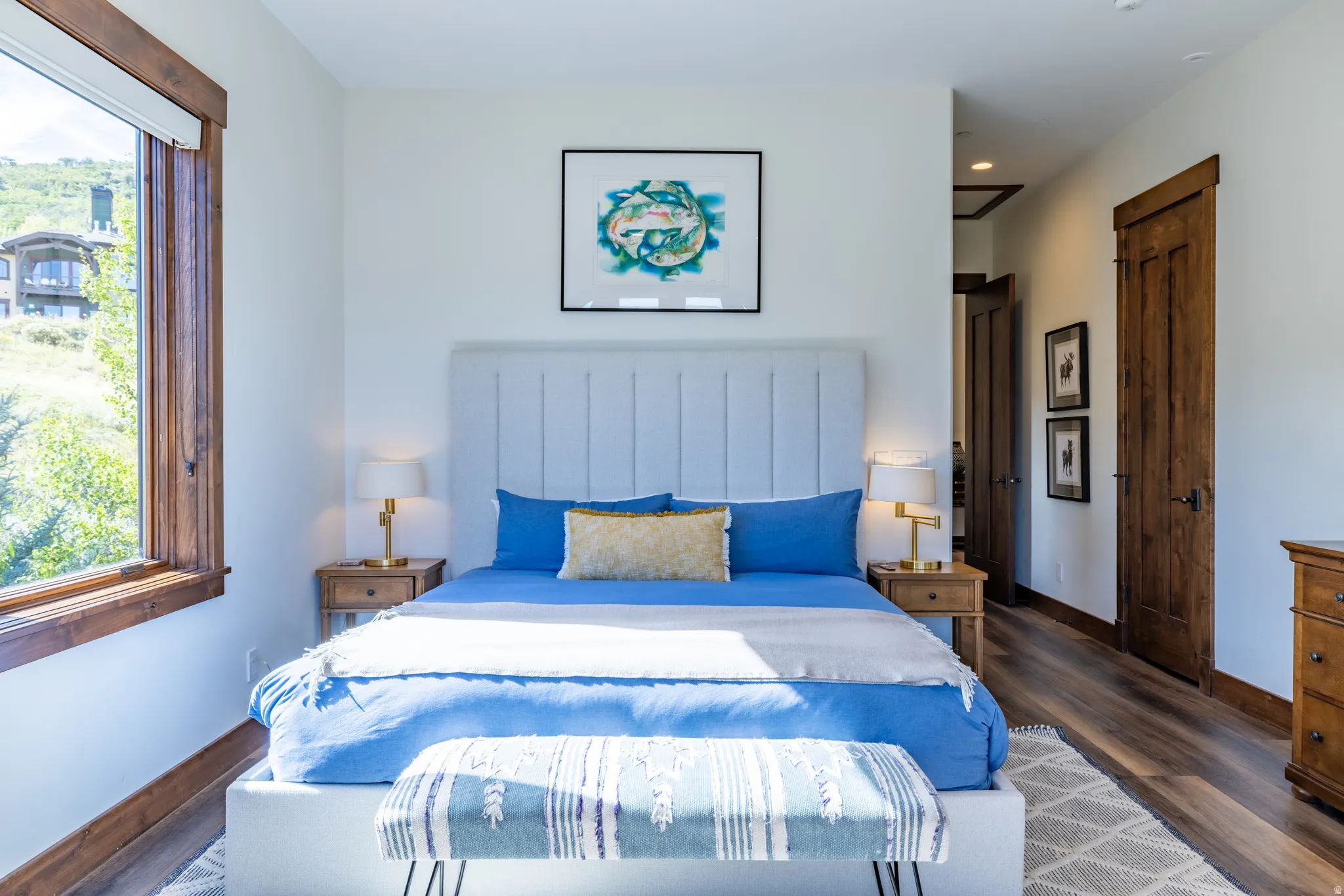 White walls complement wood-finish flooring and solid wood interior doors