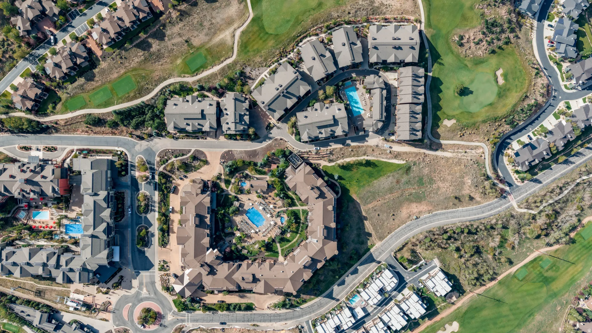 Residential community featuring multiple buildings, swimming pools, and green spaces