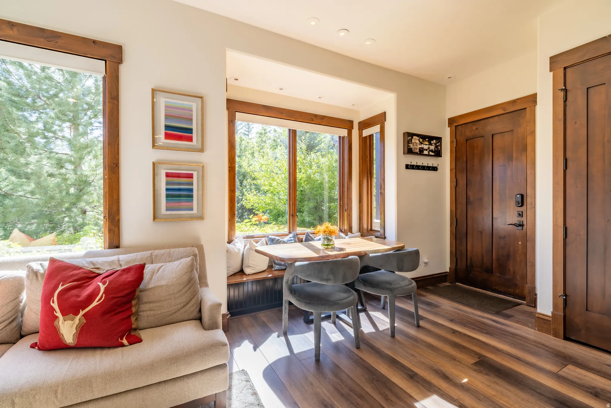 Wood-finish flooring throughout, complemented by rich wood-trimmed windows