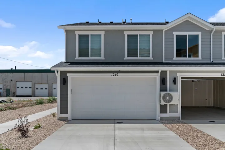 Gray exterior with white trim, two-car garage, and concrete driveway