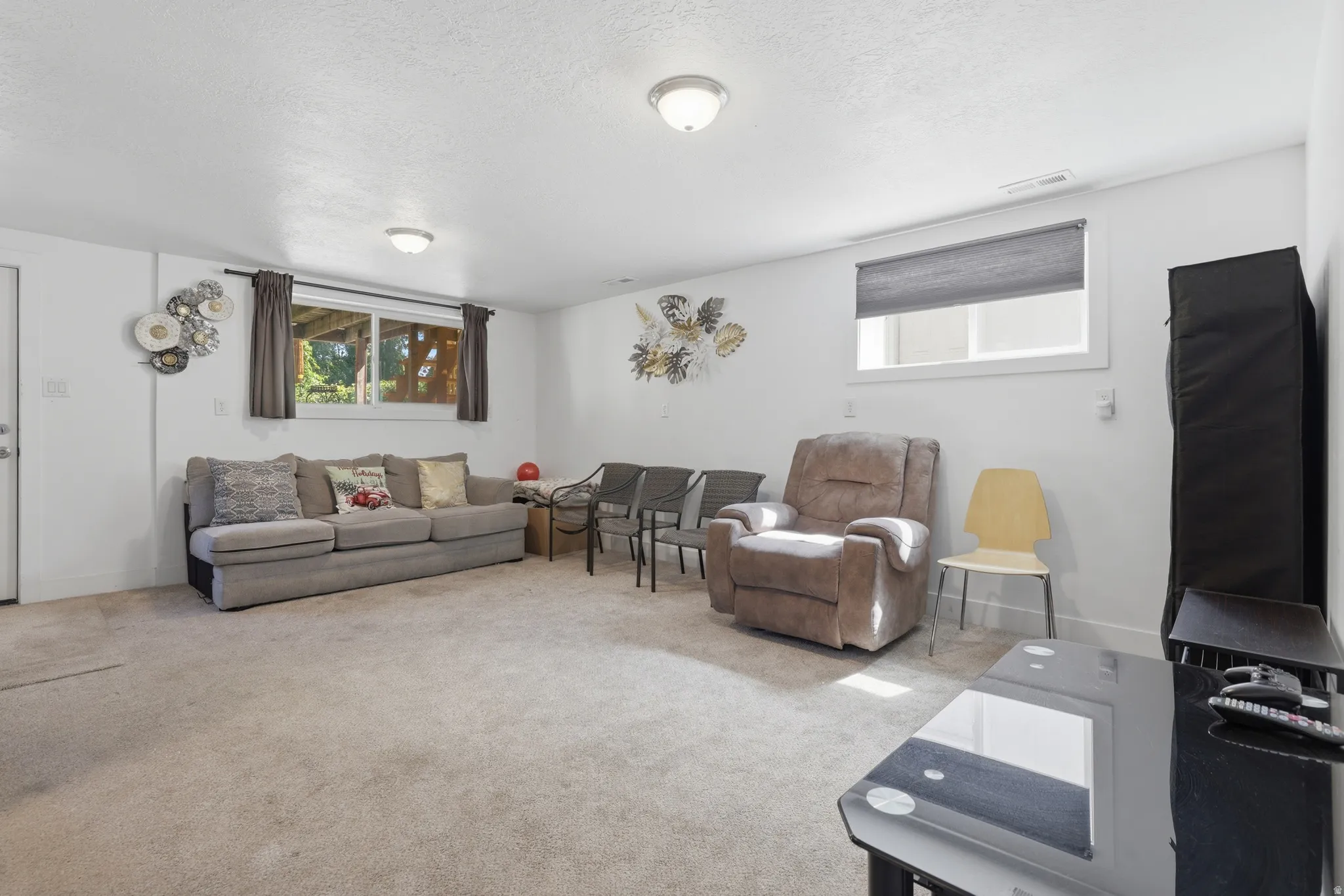 Carpeted floor, neutral wall paint, recessed lighting, and windows with natural light
