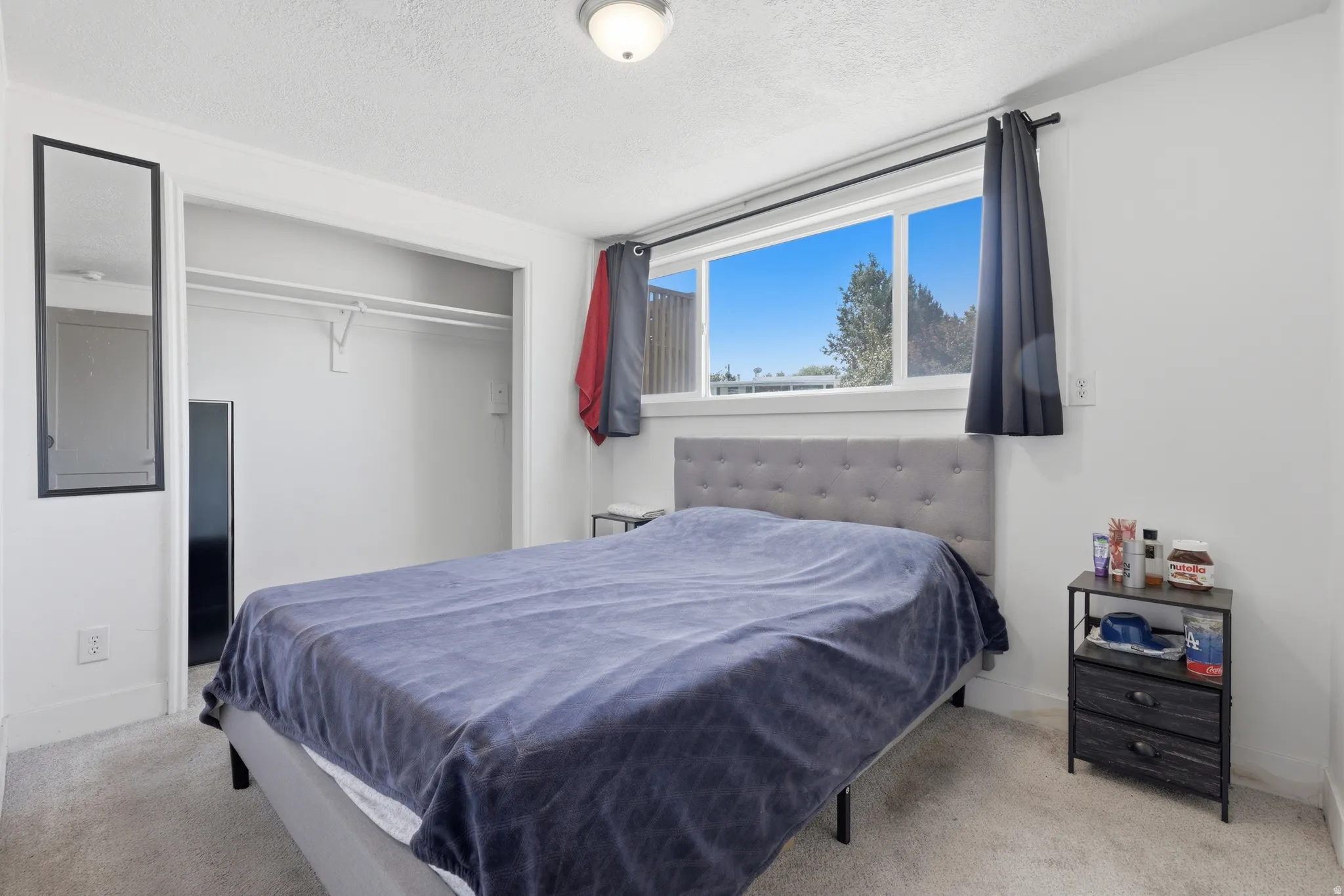 White walls complement the light-toned carpet