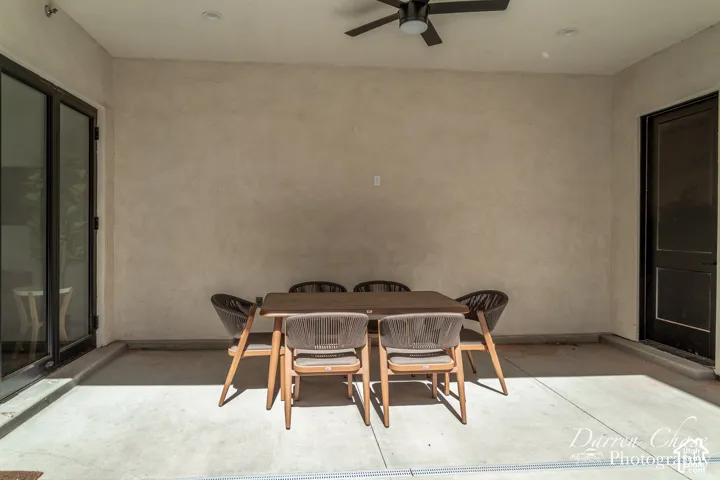 Covered patio featuring smooth stucco walls, concrete flooring, a ceiling fan, recessed lighting, and glass-paneled entry doors