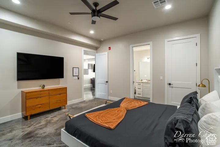 Polished concrete flooring, recessed ceiling lighting, a modern ceiling fan, and Shaker-style interior doors with matte black hardware