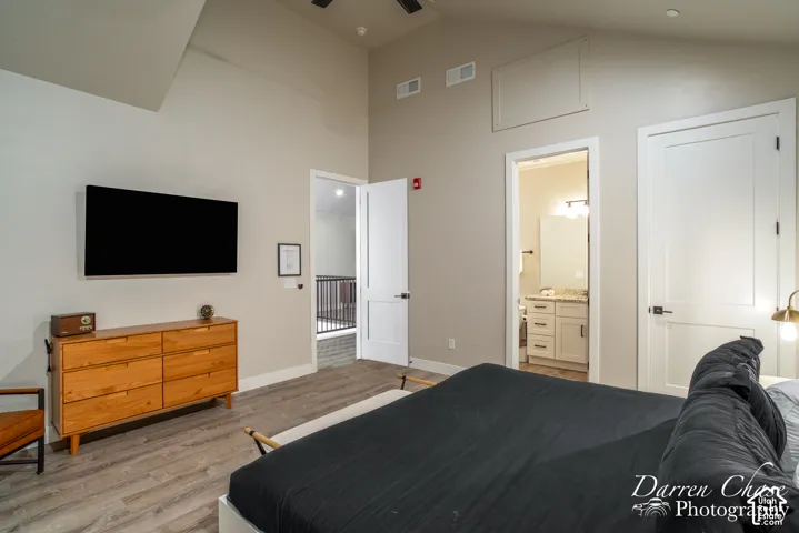 Vaulted ceilings, wood-finish flooring, two-panel interior doors, and neutral wall color