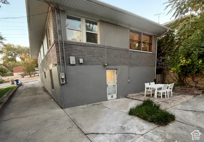 Multi-level exterior with a gray brick accent wall and painted lower level