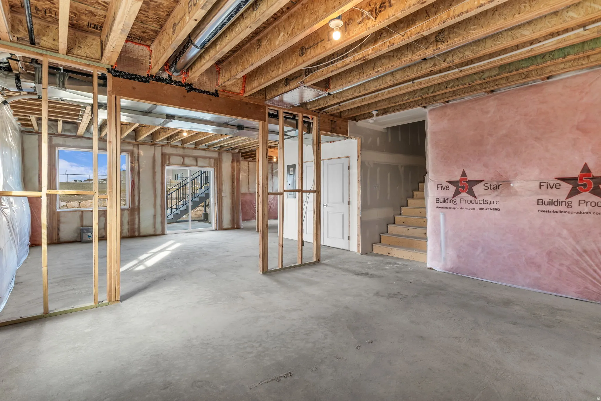 Unfinished lower level with walk-out to backyard. Well lit basement with natural light streaming into the space.