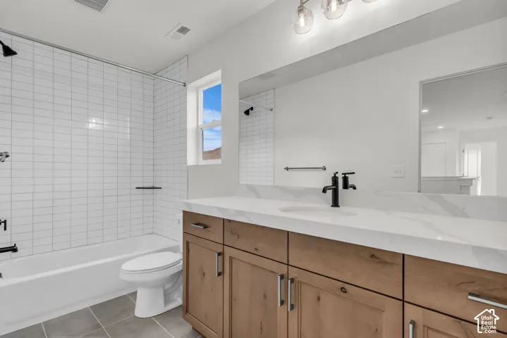 Spa-inspired secondary bathroom featuring a wood stained cabinetry with ample storage, white quartz countertop, and matte black fixtures and hardware.