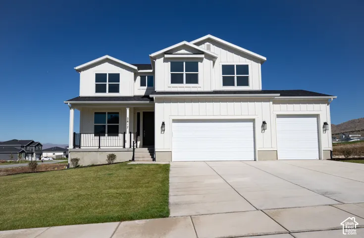 Farmhouse two-story home featuring a striking gabled roofline with large covered porch, an expansive front-load three-car garage with RV sized garage door in third bay.