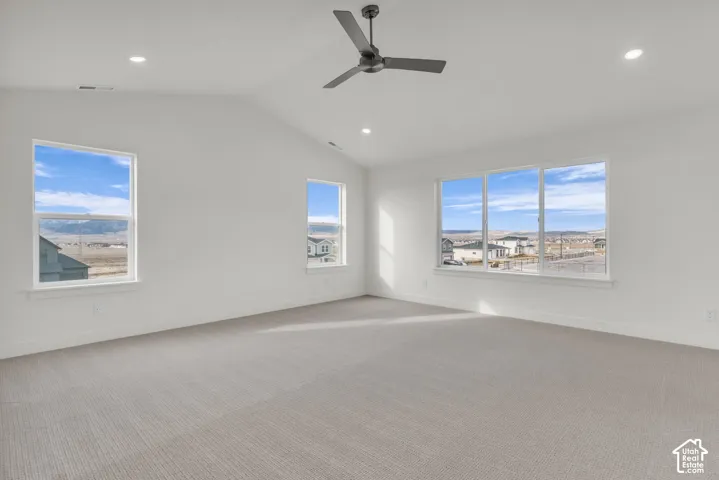 Bright corner room flooded with natural light through multiple expansive windows showcasing panoramic landscape vistas