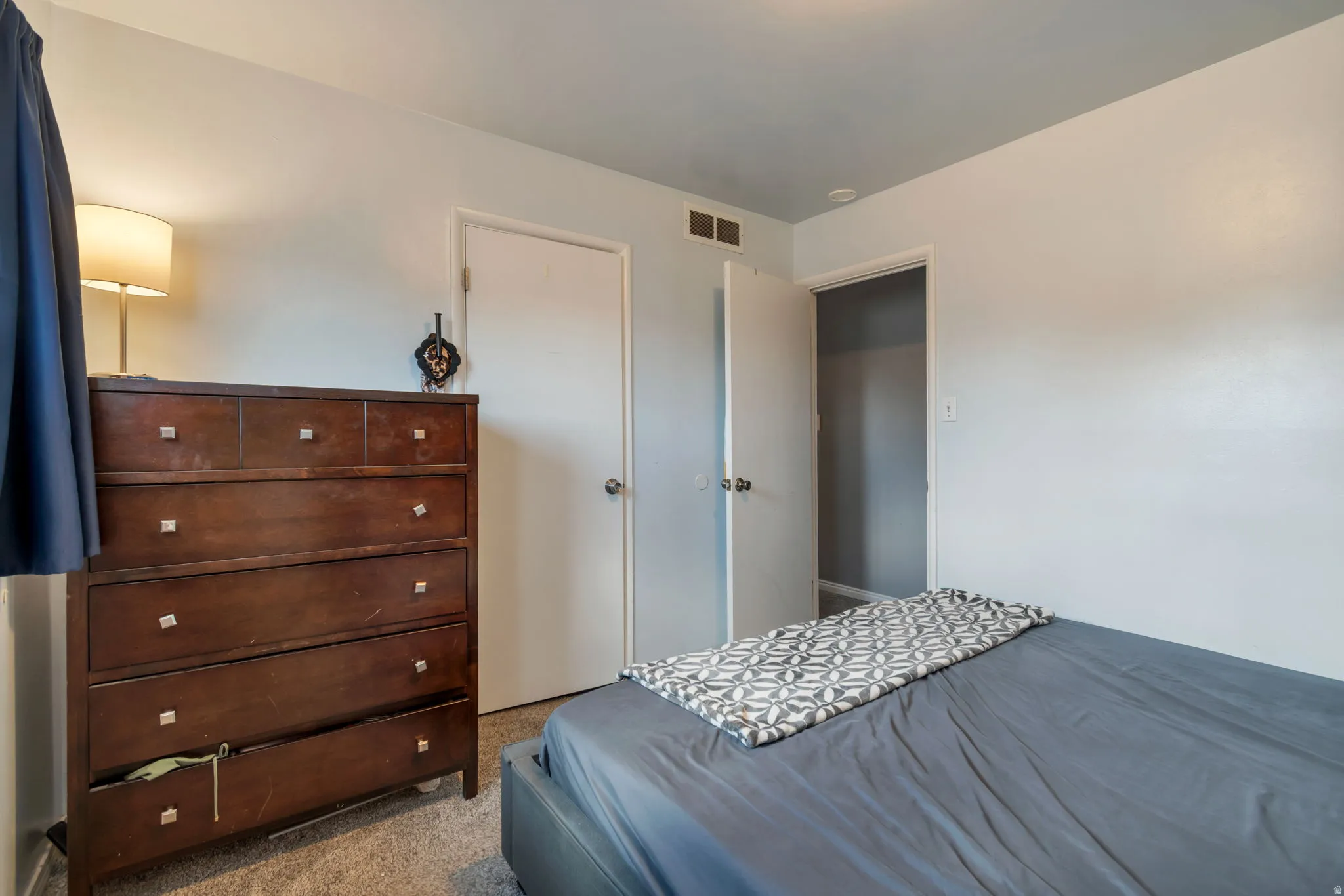 Carpeted flooring, white interior doors, and neutral wall paint