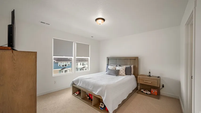 Recessed lighting, wood-finish flooring, and white walls
