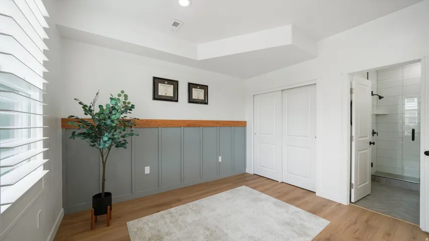 Recessed lighting, wood-finish flooring, and board and batten wall paneling