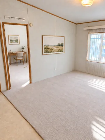 Light-toned carpet flooring with a contrasting tile entry