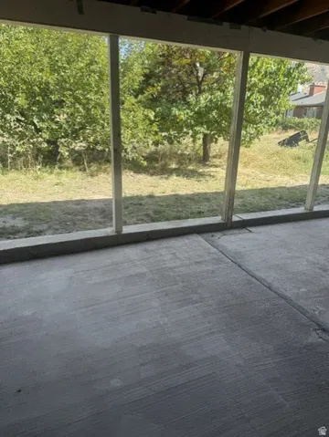 Concrete patio with a structural wood beam ceiling