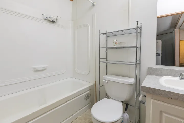 2nd Bathroom. Tub-shower combination with white surround
