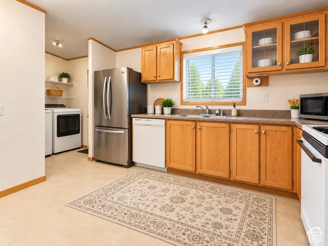 Kitchen featuring wood-finish cabinetry, stainless steel appliances, and a window above the sink