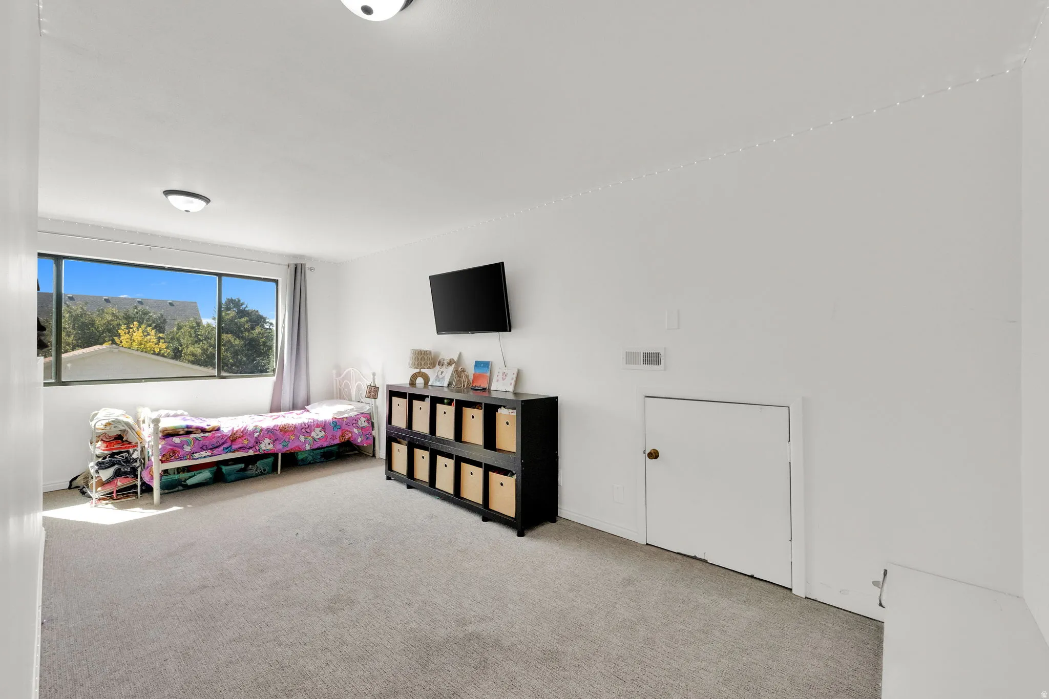 Wall-to-wall carpeting with natural light from a large window