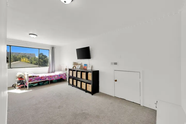 Wall-to-wall carpeting with natural light from a large window