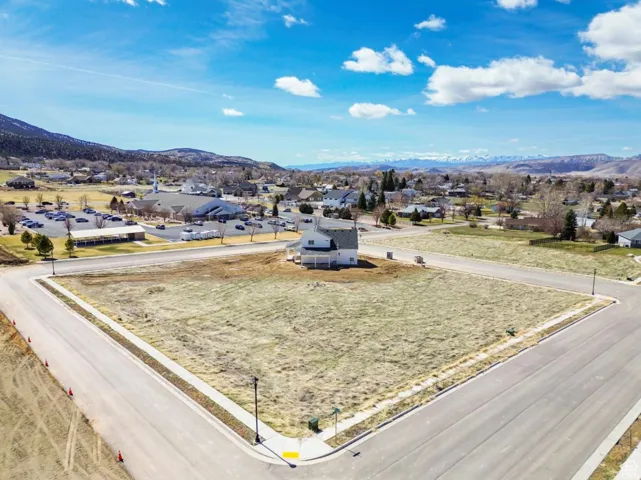 Expansive corner lot with paved streets and established sidewalks