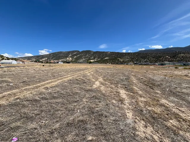 Expansive parcel featuring a clear, level terrain and distant mountain scenery