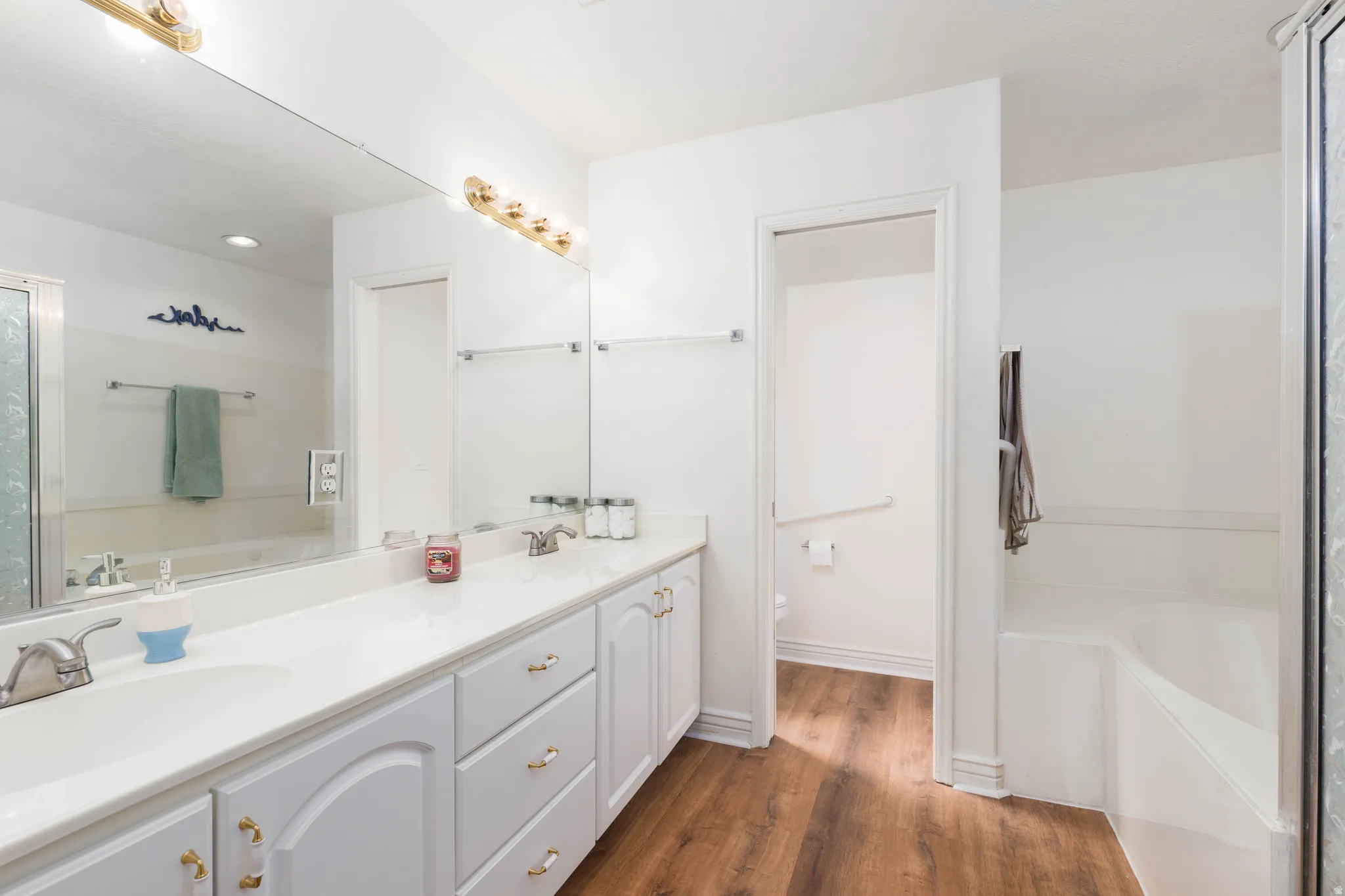 Dual vanity with white cabinetry and integrated sinks
