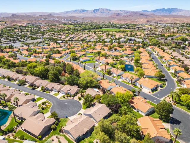 Residential neighborhood with a mountain backdrop, featuring a cul-de-sac and houses with tile roofs