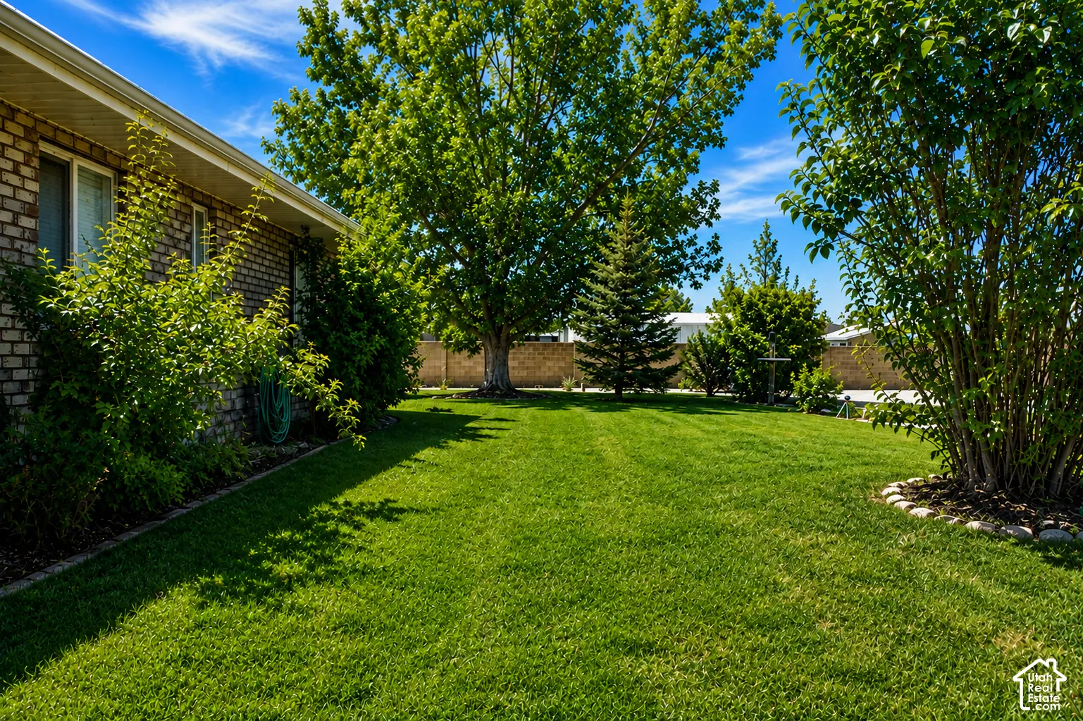 Expansive lawn area, mature trees, and surrounding shrubbery
