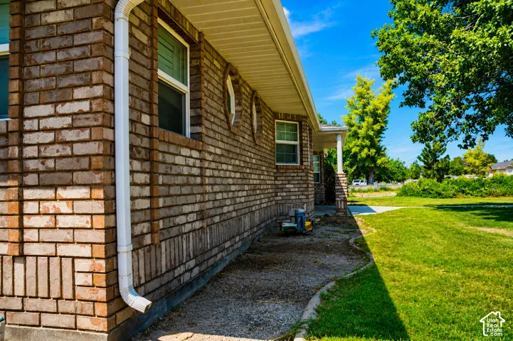 Brick exterior with white window trim and round accent windows