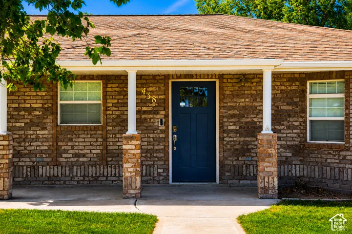 Brick exterior with a dark blue entry door
