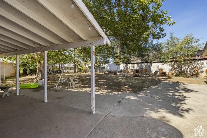 Covered patio with string lighting and a concrete surface
